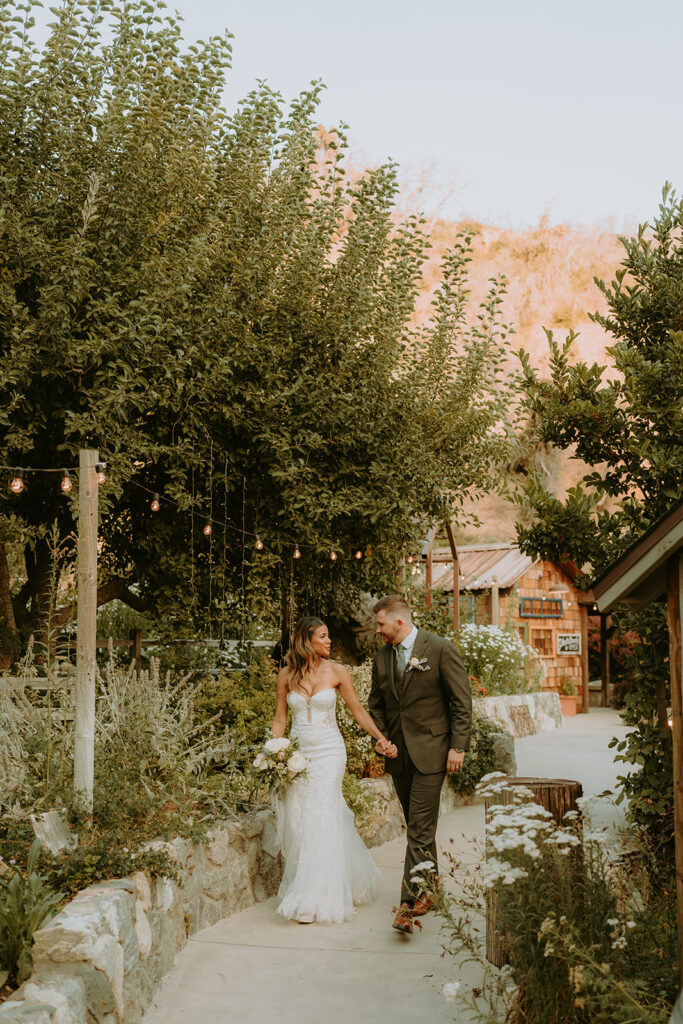 bride and groom surrounded by large trees