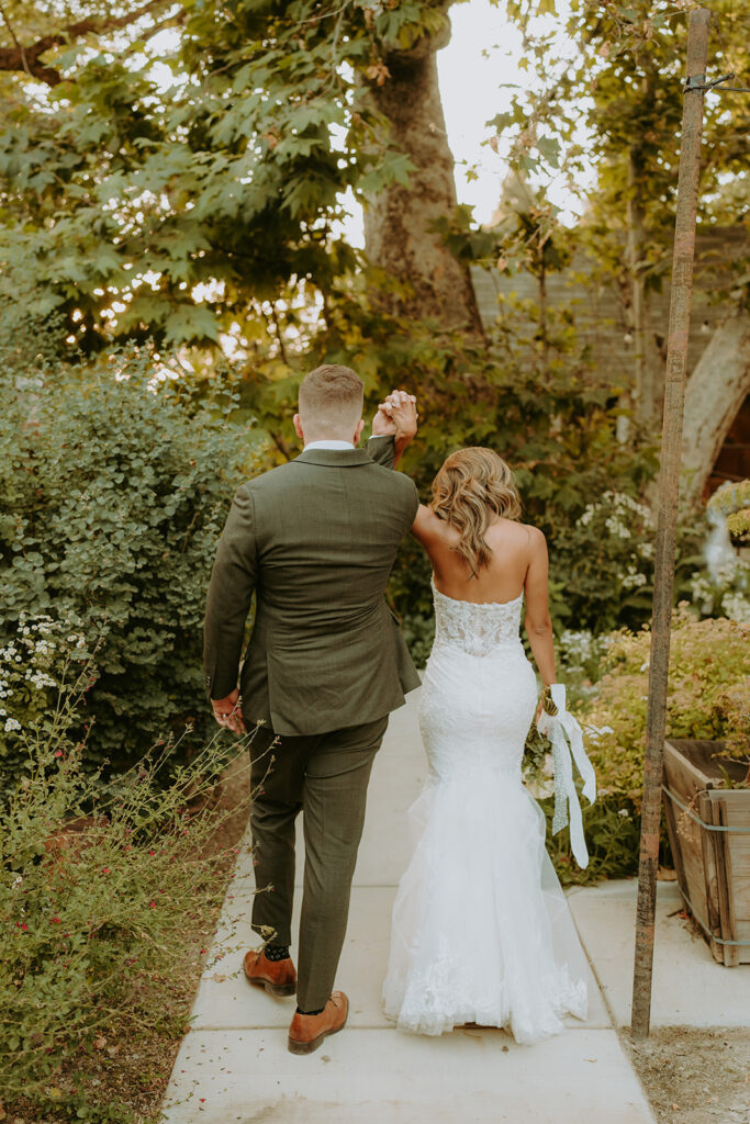 bride and groom surrounded by large trees