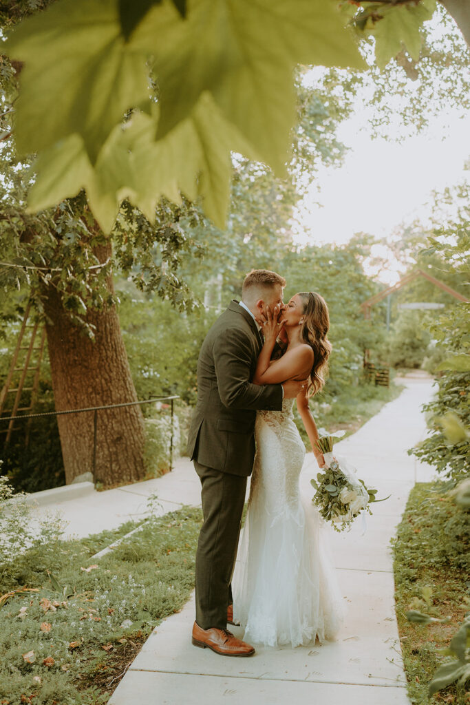 bride and groom surrounded by large trees