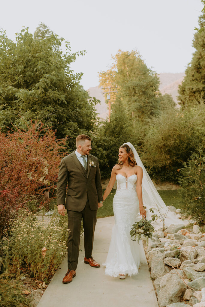 bride and groom surrounded by large trees