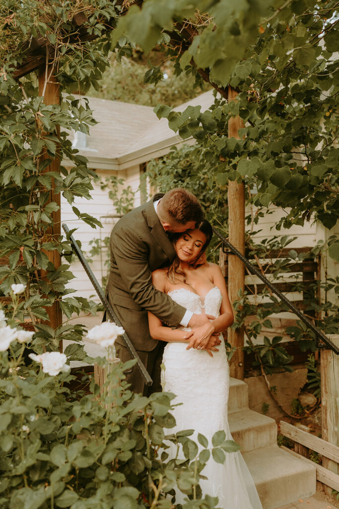 bride and groom surrounded by large trees