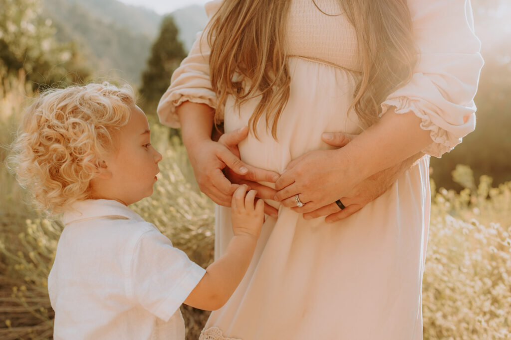 Fall maternity session in the Southern California mountains during golden hour, featuring warm autumn tones and stunning mountain views