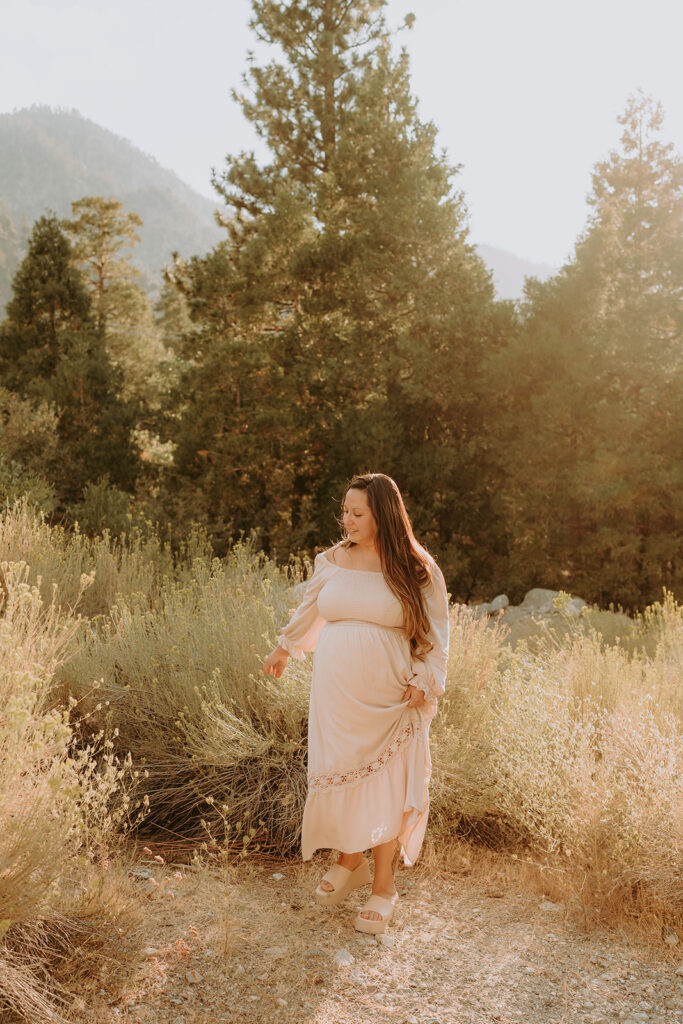 Fall maternity session in the Southern California mountains during golden hour, featuring warm autumn tones and stunning mountain views