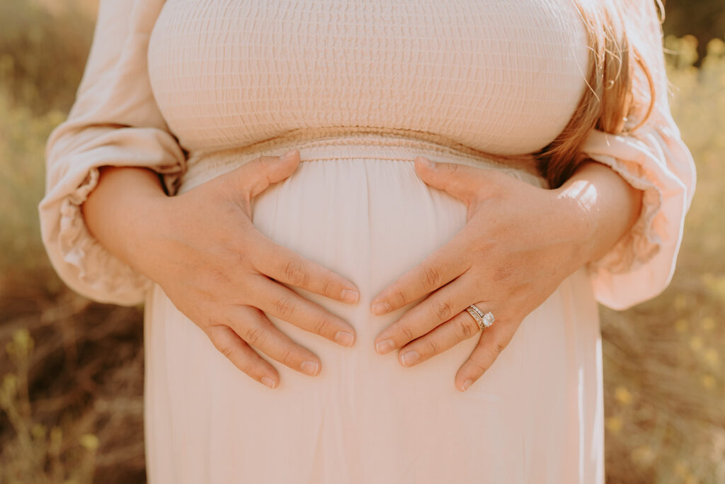 Fall maternity session in the Southern California mountains during golden hour, featuring warm autumn tones and stunning mountain views