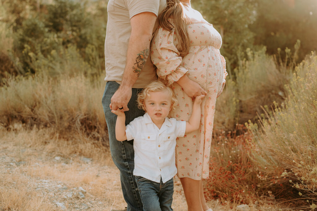 Fall maternity session in the Southern California mountains during golden hour, featuring warm autumn tones and stunning mountain views