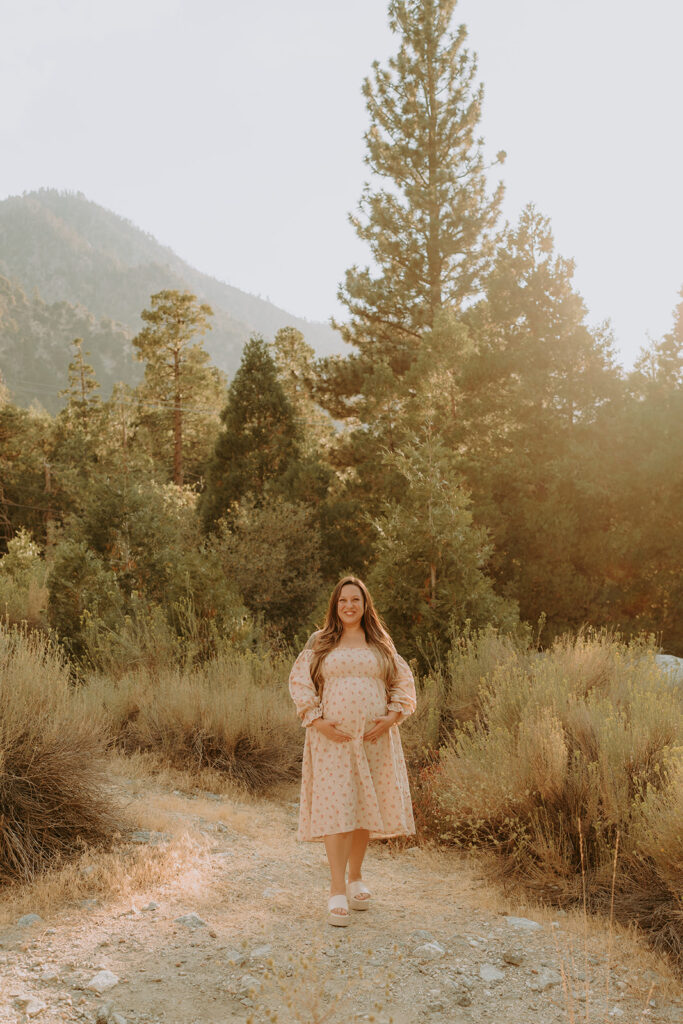 Fall maternity session in the Southern California mountains during golden hour, featuring warm autumn tones and stunning mountain views