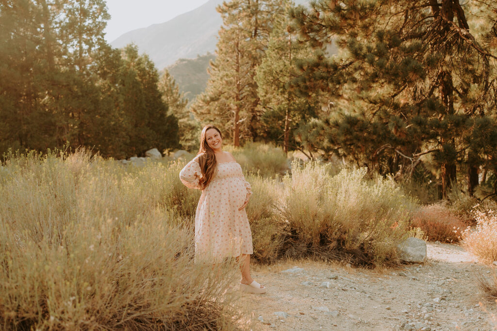 Fall maternity session in the Southern California mountains during golden hour, featuring warm autumn tones and stunning mountain views