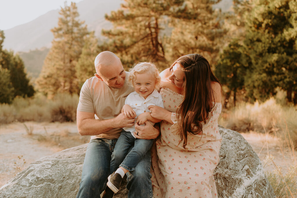 Fall maternity session in the Southern California mountains during golden hour, featuring warm autumn tones and stunning mountain views