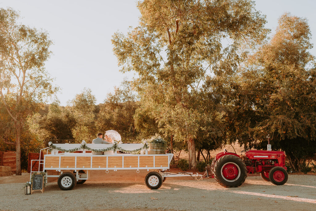 Rustic tractor shuttle at Sacred Oak Vineyard, a unique transportation option for wedding guests.
