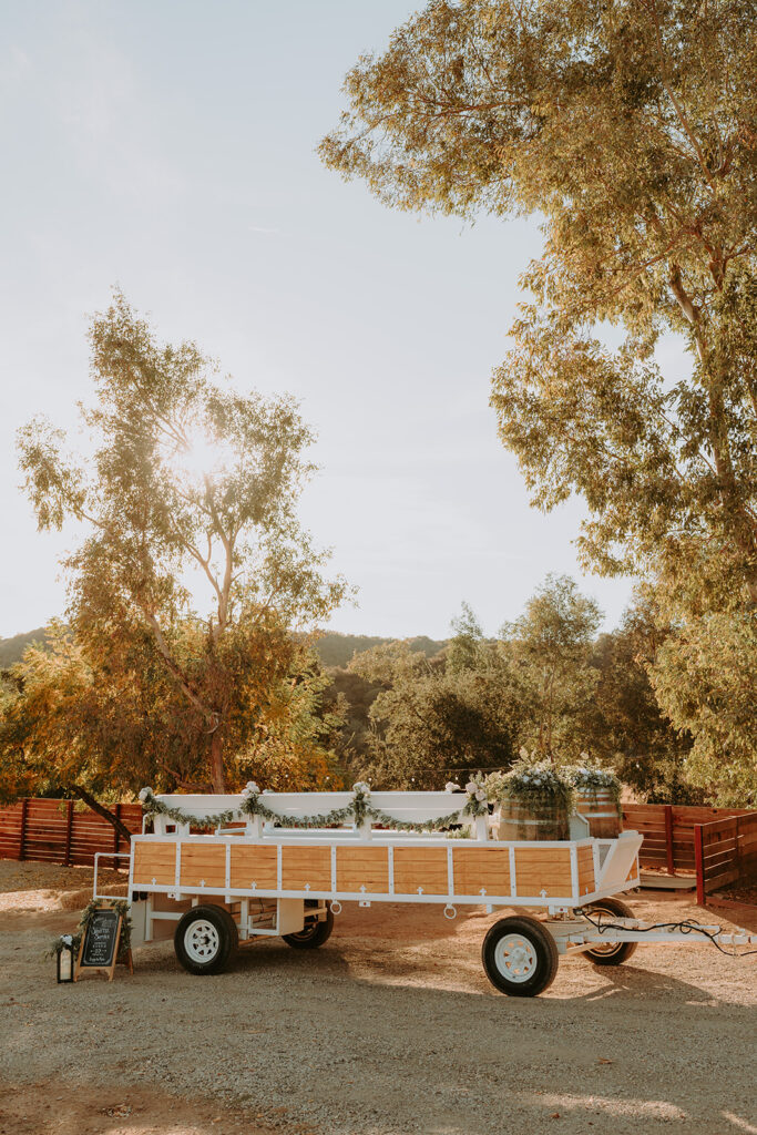 Rustic tractor shuttle at Sacred Oak Vineyard, a unique transportation option for wedding guests.