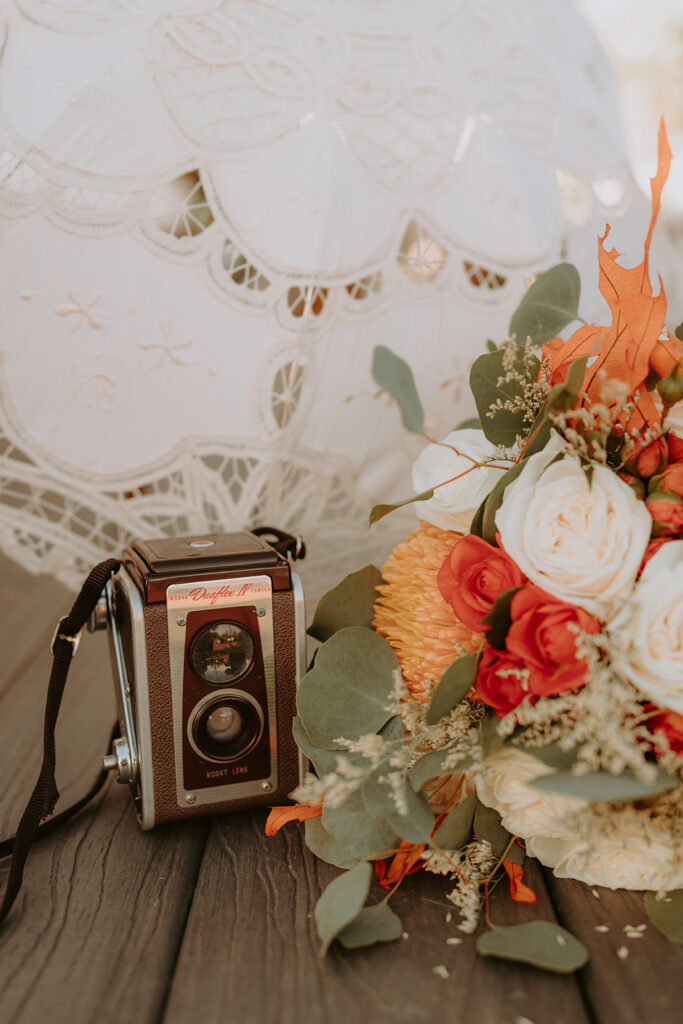 Rustic wedding decor with wine barrels and floral arrangements at Sacred Oak Vineyard in Cherry Valley.