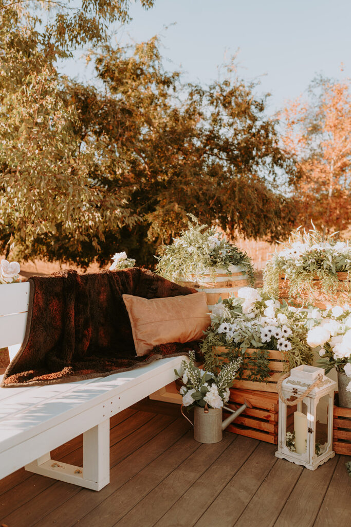 Rustic wedding decor with wine barrels and floral arrangements at Sacred Oak Vineyard in Cherry Valley.