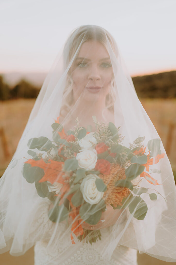 Bride in a flowing gown standing at Sacred Oak Vineyard, ideal for romantic outdoor wedding photography