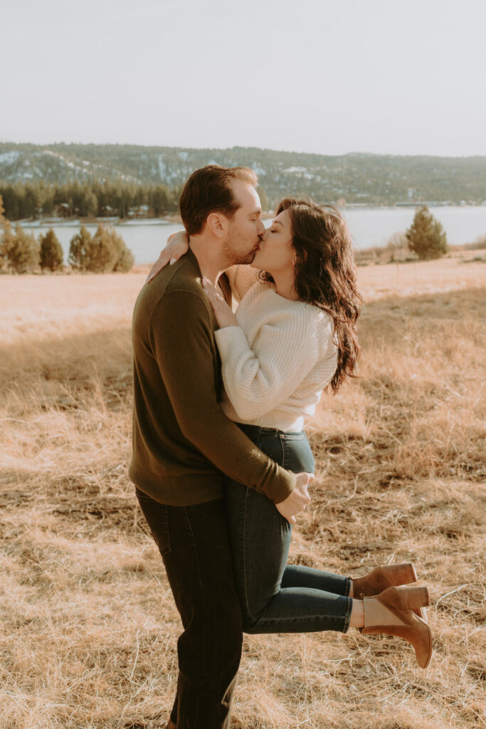 engaged couple hugging and kissing in Big Bear