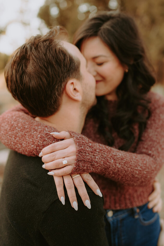close up of newly engaged couple in the forest