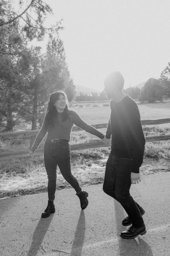 black and white of a man and women holding hands