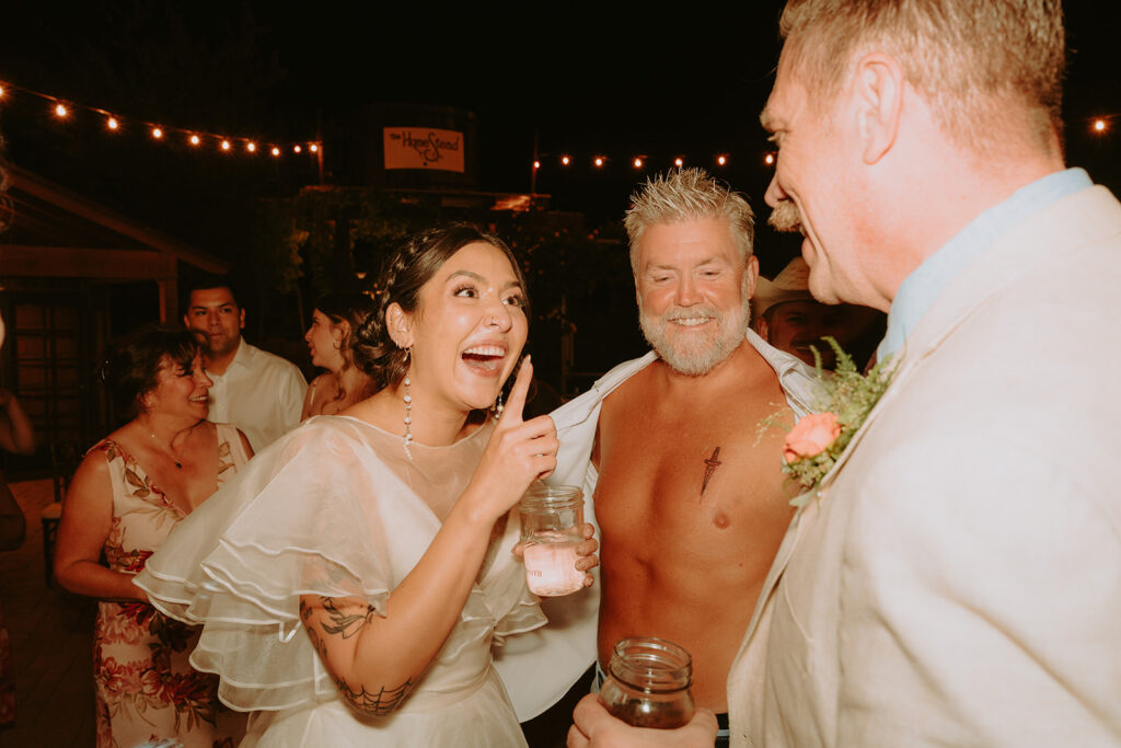 Father of the bride showing his first tattoo during wedding celebration