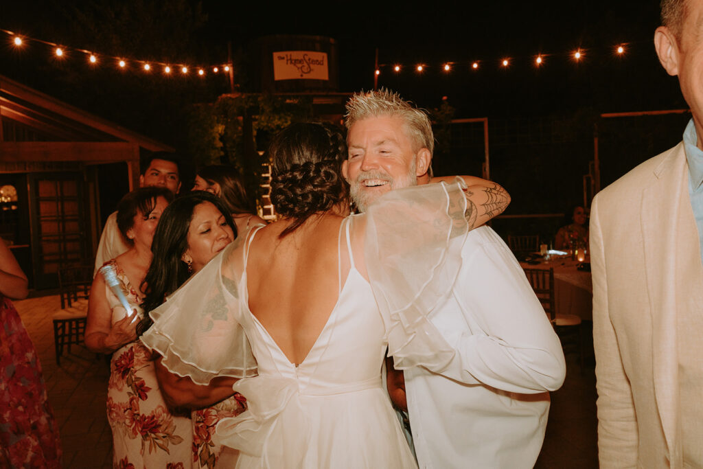 Father of the bride showing his first tattoo during wedding celebration
