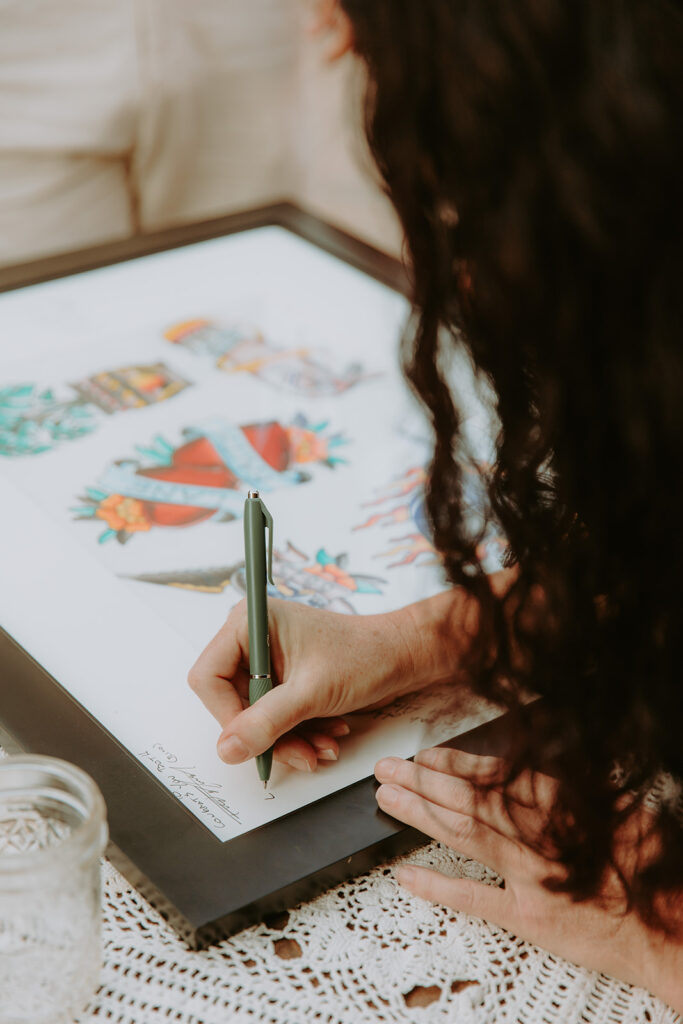 Tattoo flash sheet displayed at wedding tattoo booth