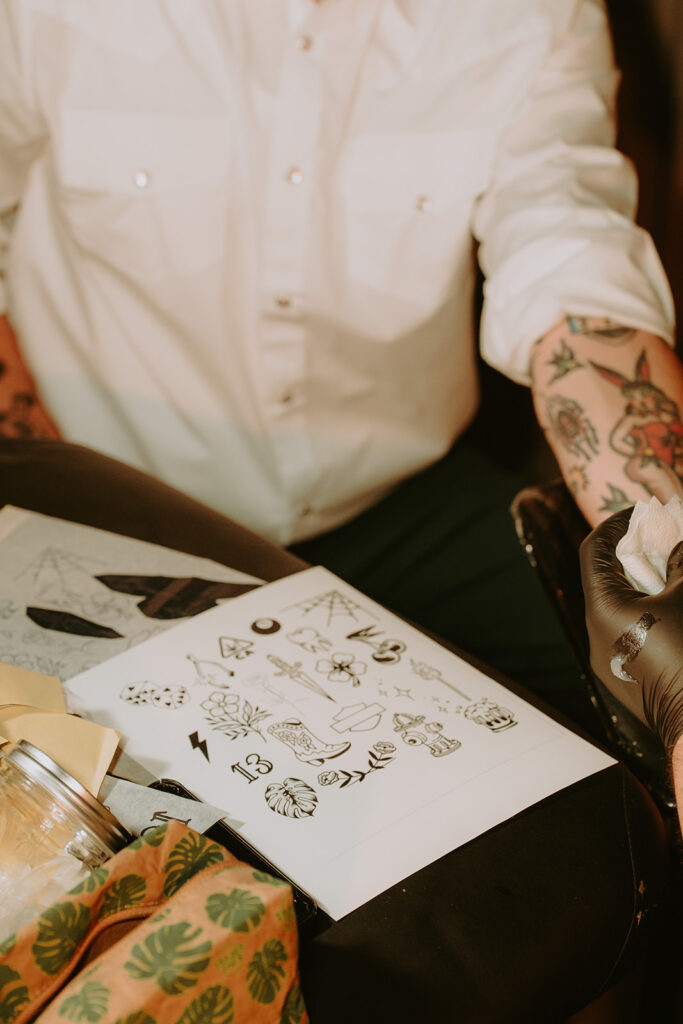 Tattoo flash sheet displayed at wedding tattoo booth